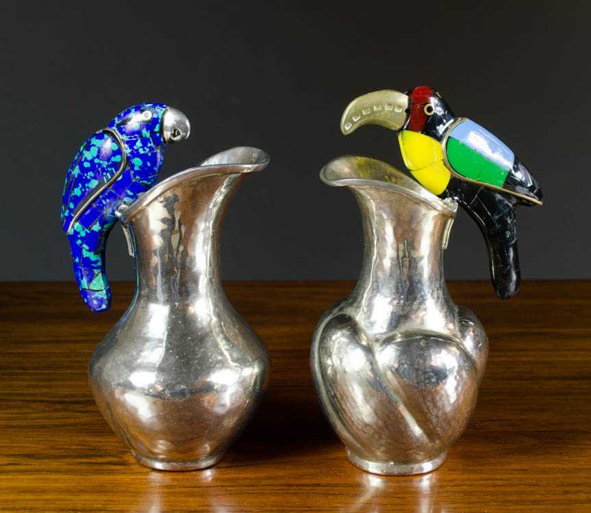 Appraisal: TWO MEXICAN SILVER PLATED PITCHERS each with figural bird handles