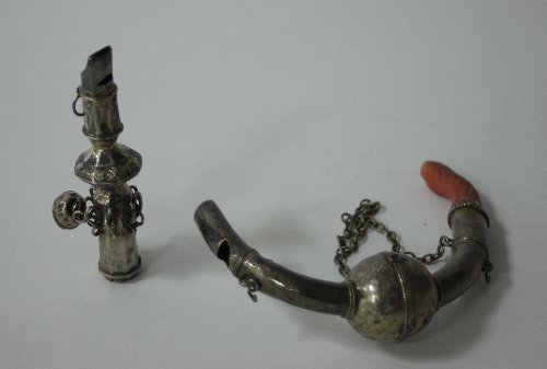 Appraisal: A child's white metal rattle of curved form with coral