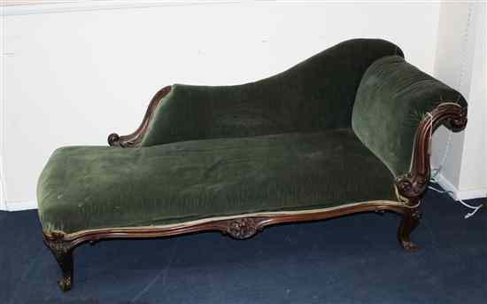 Appraisal: An early Victorian caved mahogany chaise longue on scroll feet