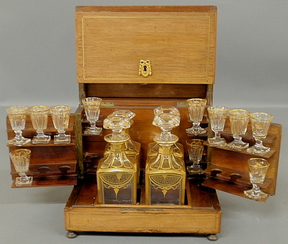 Appraisal: - Mahogany tantalus or cordial set c with brass line