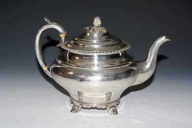 Appraisal: A VICTORIAN SILVER TEAPOT baluster shaped standing on shell and