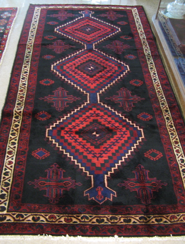 Appraisal: PERSIAN ZANJAN CARPET the plain black field adorned with cruciform