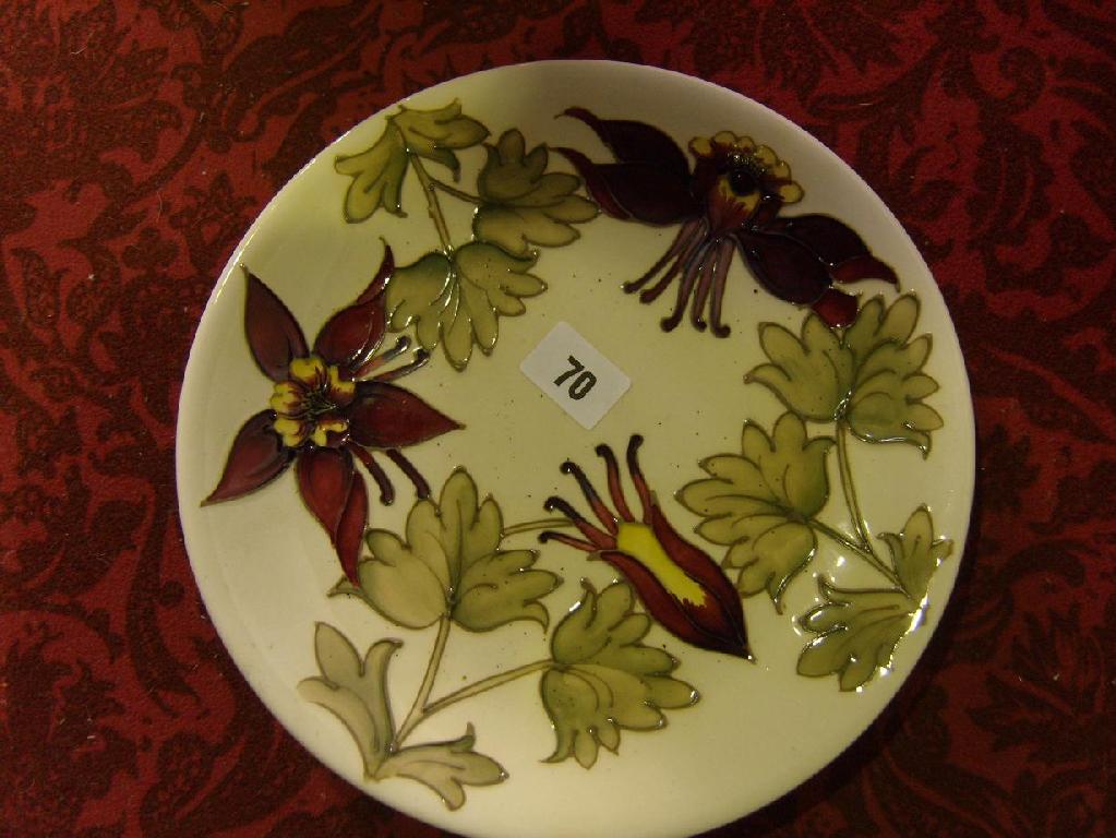 Appraisal: A boxed cream ground Moorcroft plate with red and yellow