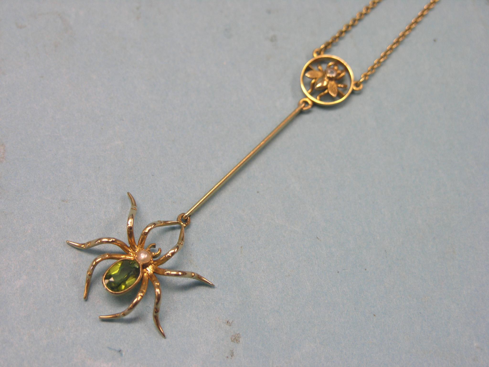 Appraisal: An unusual yellow metal spider pendant set green stone and