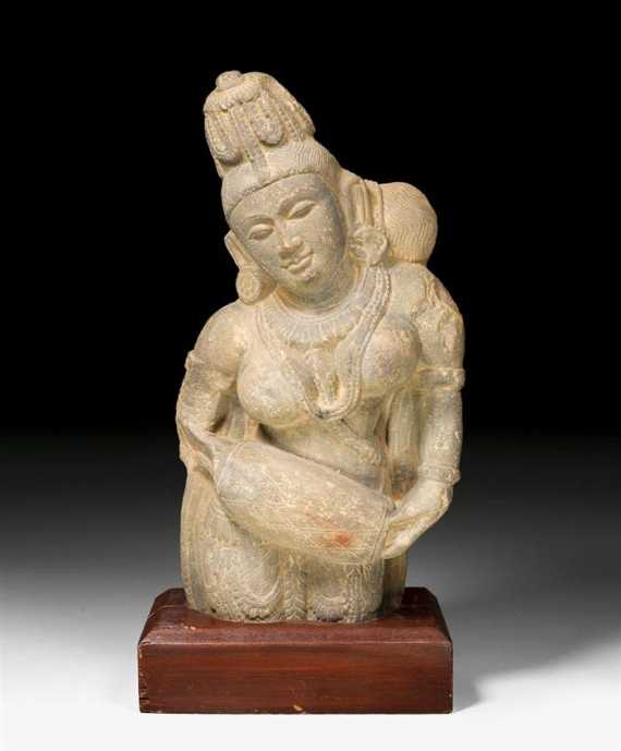 Appraisal: A GREY STONE BUST OF A YAKSHI HOLDING A DRUM