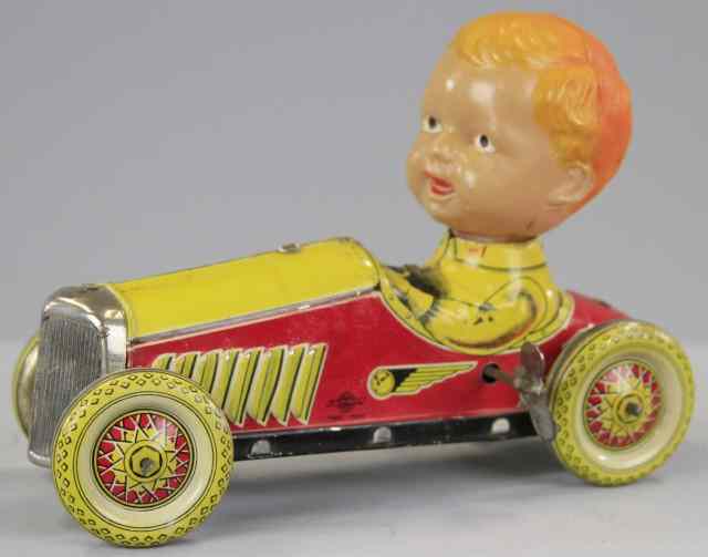 Appraisal: BOY RIDING RACE CAR Pre-war Japan lithographed tin open racer