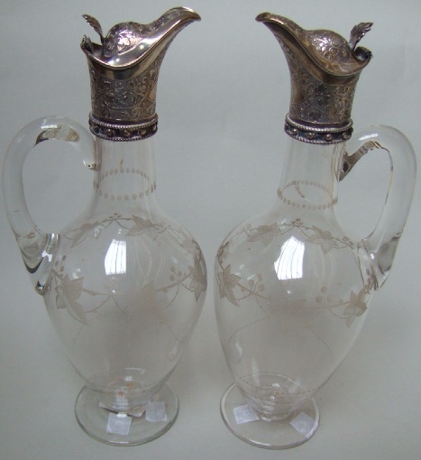 Appraisal: A pair of Victorian silver mounted glass claret jugs the