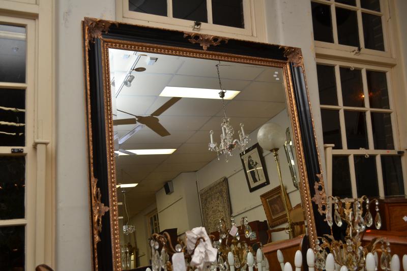 Appraisal: A LARGE DECORATIVE EBONISED AND GILT WALL MIRROR WITH BEVELLED