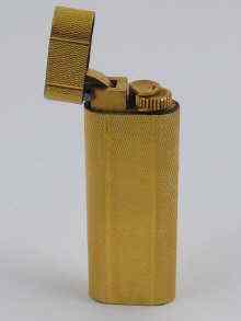 Appraisal: A gold plated Cartier lighter in leather Cartier case