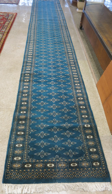 Appraisal: HAND KNOTTED BOKHARA RUNNER Pakistan or India repeating minor Turkoman