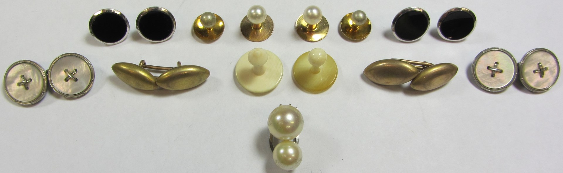 Appraisal: Four ct white gold and black onyx set dress buttons