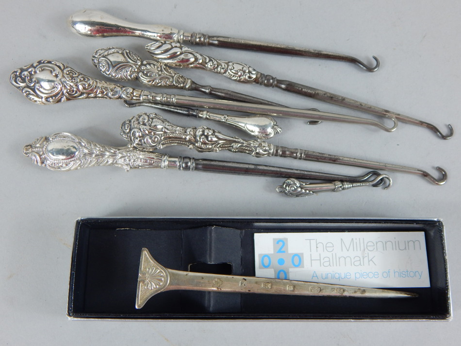 Appraisal: A collection of silver mounted button hooks a millennium silver