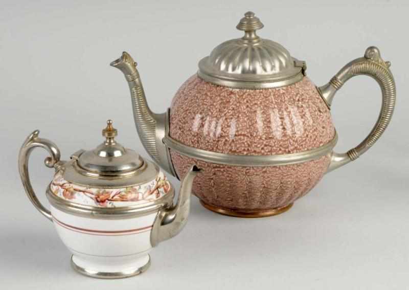 Appraisal: Lot of Graniteware Teapots Description Both with metal trim Includes