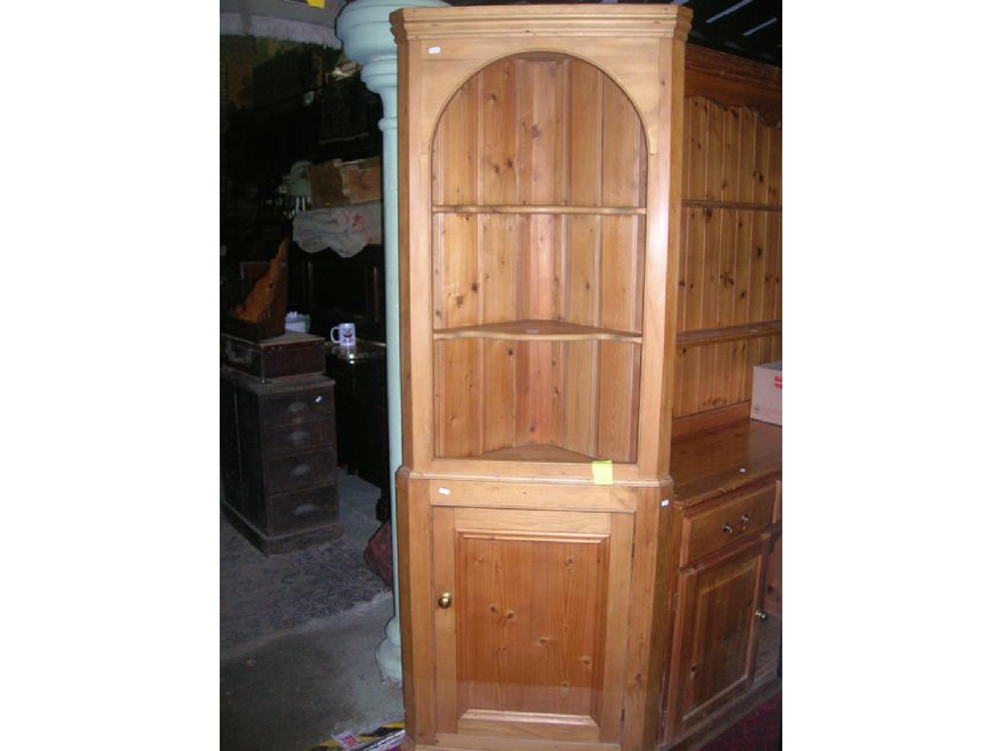 Appraisal: A Georgian style stripped pine two sectional freestanding corner cupboard