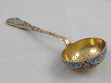 Appraisal: A Russian style cloisonne enamel and silver gilt sifter spoon