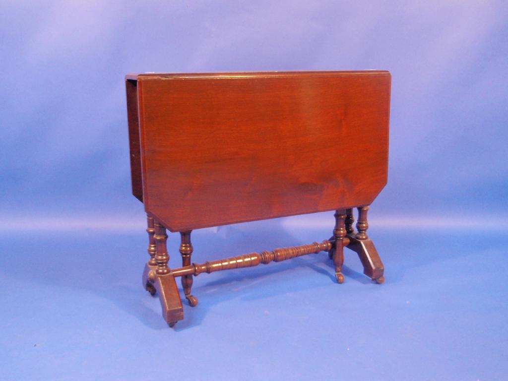 Appraisal: A Victorian walnut Sutherland table with moulded and canted top