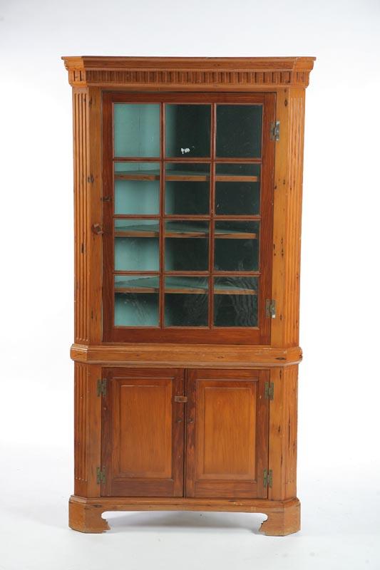 Appraisal: CORNER CUPBOARD Pine with a dentil carved cornice twelve pane