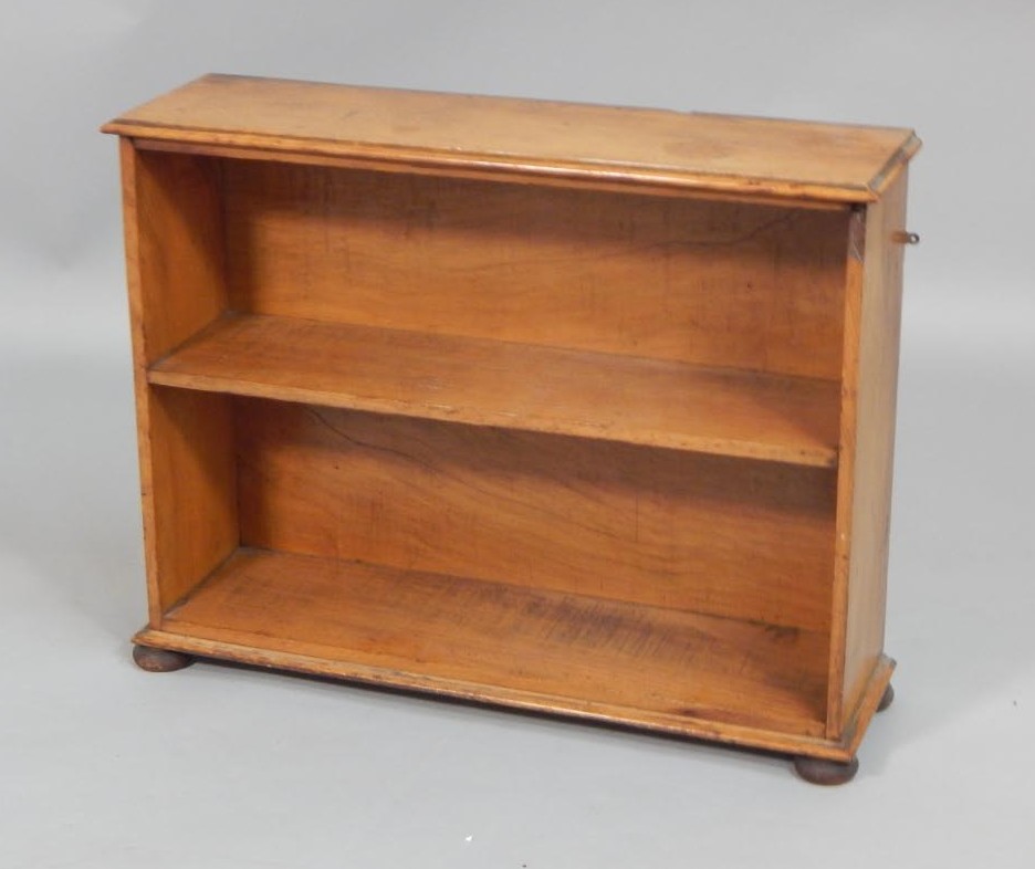 Appraisal: A small Victorian pine open bookcase on bun feet cm