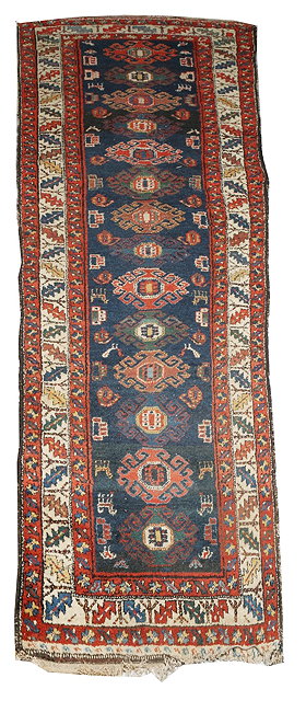 Appraisal: A HAMADAN BLUE GROUND RUNNER decorated with central stylistic medallions