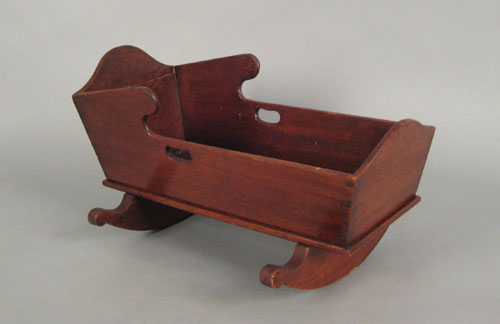 Appraisal: Pennsylvania walnut dolls cradle ca with scalloped foot board and