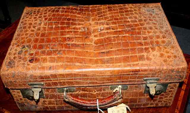 Appraisal: A CROCODILE SKIN TRAVELLING CASE with ivory fittings to include