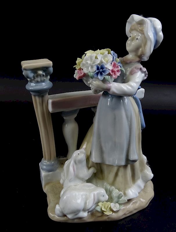 Appraisal: Lladro Porcelain Figure Of Girl Holding Flowers Lladro Porcelain Figure