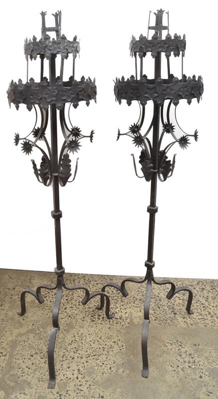 Appraisal: A PAIR OF WROUGHT IRON TORCHERES with a two-tiered crenellated