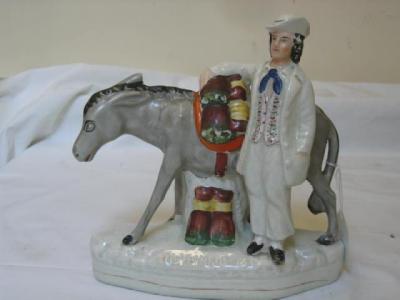 Appraisal: A VICTORIAN STAFFORDSHIRE POTTERY FIGURE Beesoms modelled as a vendor