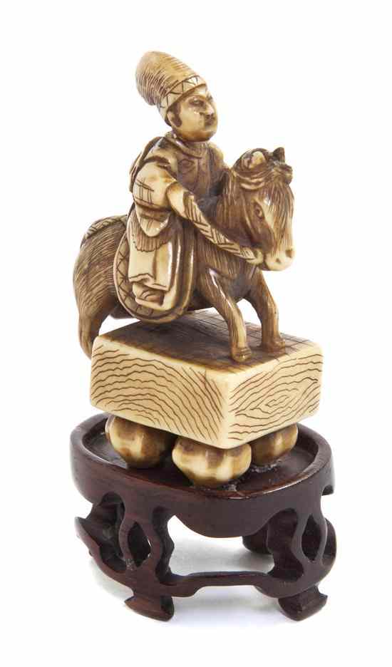 Appraisal: An Ivory Netsuke of Oguri Hangan Riding on a Go