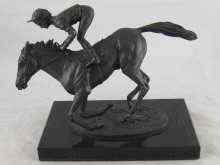 Appraisal: A bronze group of a racehorse with jokey titled ''Champion