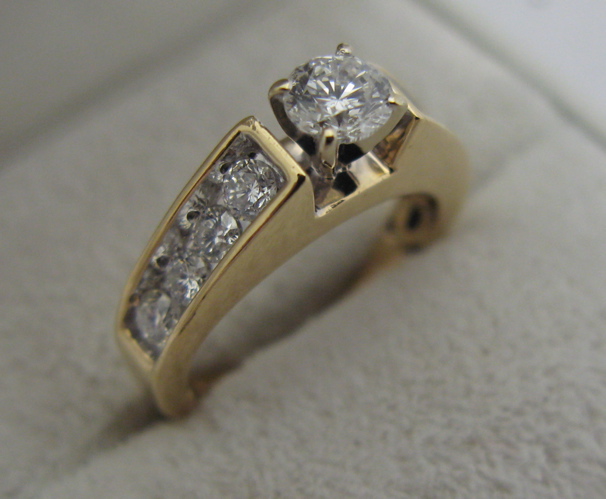 Appraisal: DIAMOND AND K GOLD RING centering a round brilliant-cut diamond