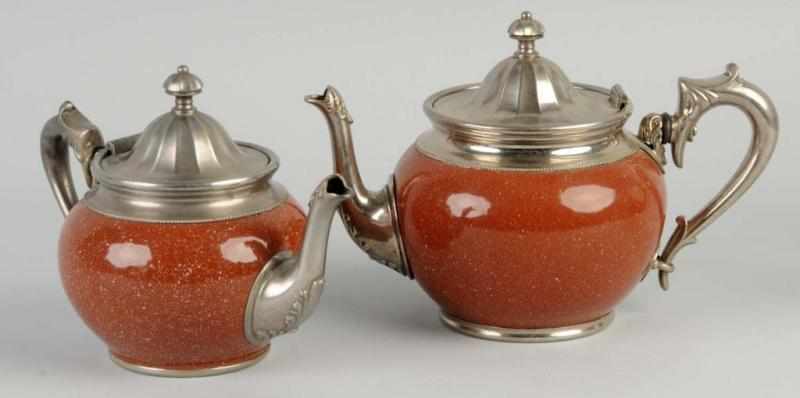 Appraisal: Lot of Brown Speckle Graniteware Teapots Description Both with metal