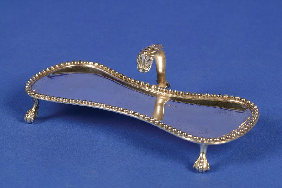 Appraisal: A GEORGE III SNUFFER STAND of waisted rectangular form with