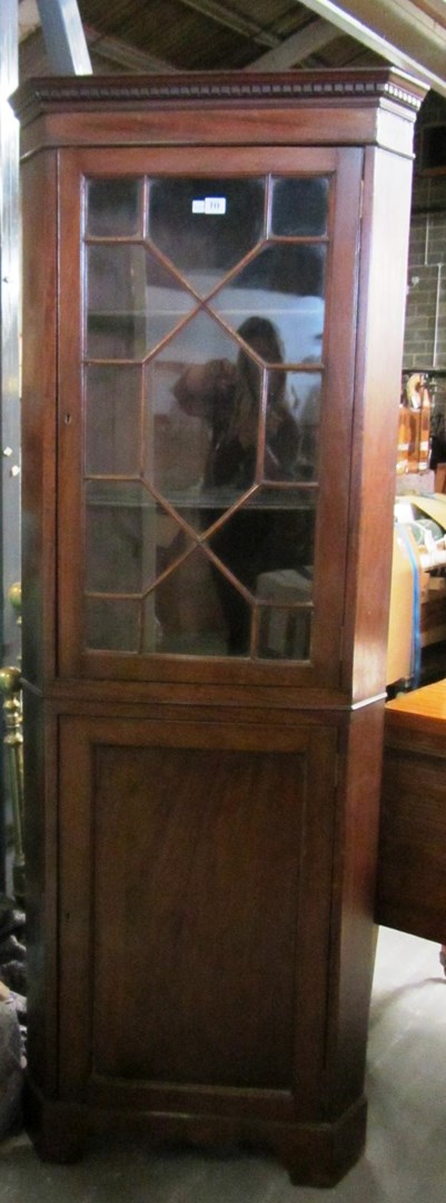 Appraisal: A George III mahogany floor standing corner display cabinet cupboard