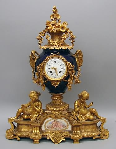 Appraisal: th century ormolu-mounted surmounted by basket of flowers on cobalt