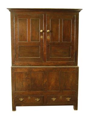 Appraisal: An early th century oak press cupboard the moulded cornice