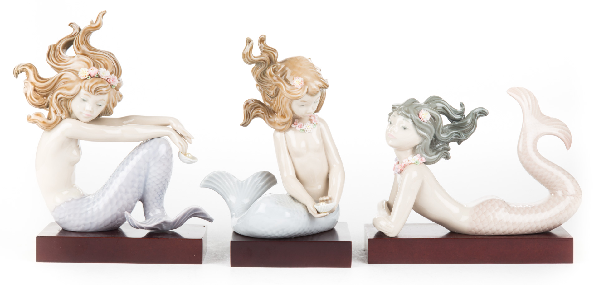 Appraisal: Lladro mermaids Illusion Fantas Mirage and porcelain figures with wood