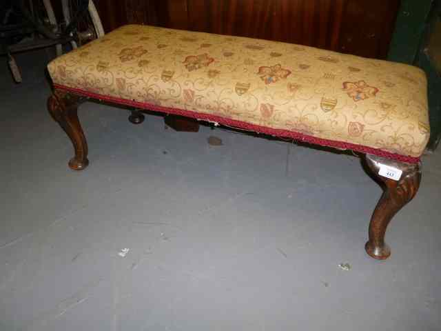 Appraisal: A LONG LOW STOOL with overstuffed upholstered seat and shell