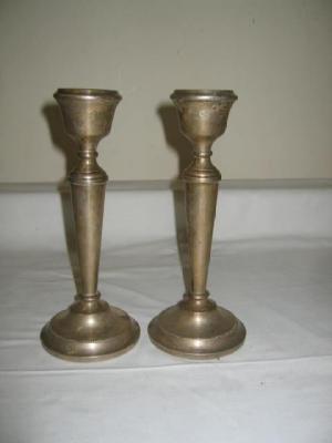 Appraisal: A PAIR OF CANDLESTICKS the urn shaped socket on turned