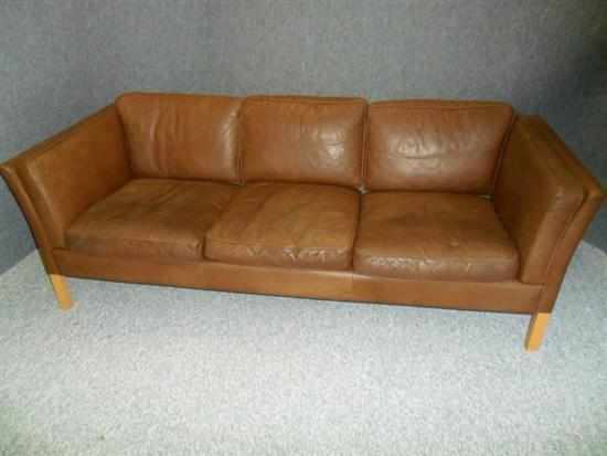 Appraisal: A STOUBY DANISH BROWN LEATHER THREE SEAT SOFA raised on