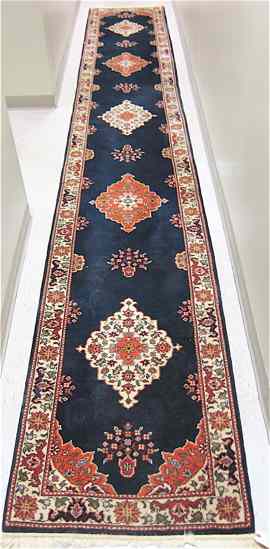 Appraisal: SIGNED AND HAND KNOTTED ROMANIAN RUNNER Persian design repeating floral