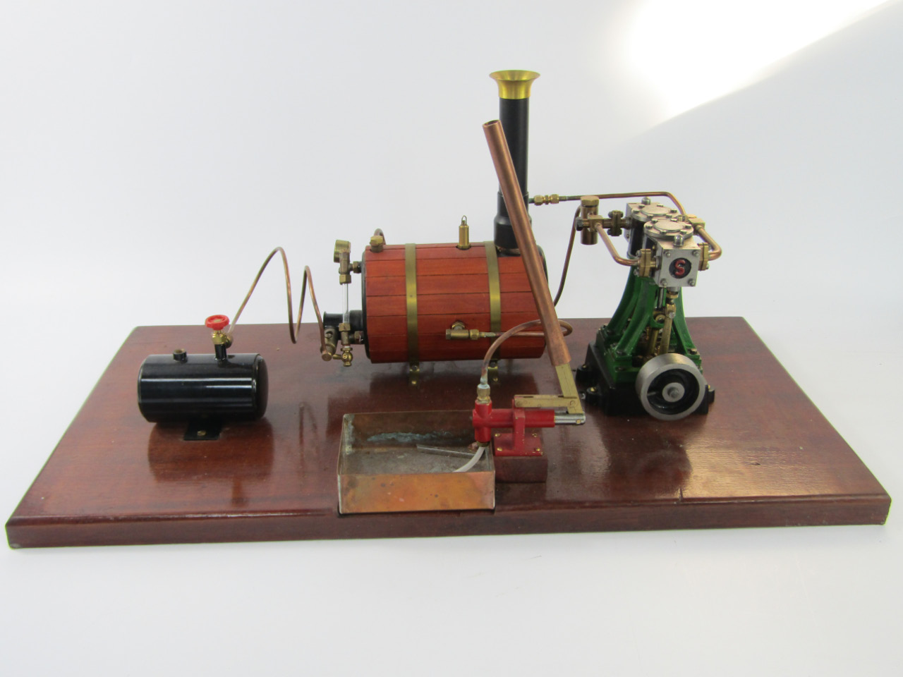 Appraisal: A Stuart live model steam standing engine mounted on a