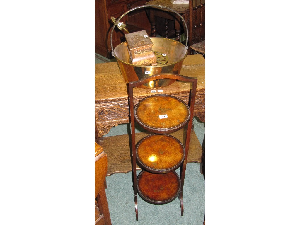 Appraisal: Mahogany folding cakestand brass jelly pan trivot toasting fork and