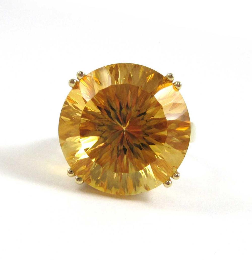 Appraisal: CITRINE AND FOURTEEN KARAT GOLD SOLITAIRE RING with yellow gold