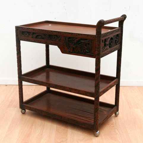 Appraisal: A heavily carved Chinese th century tea trolley circa cms