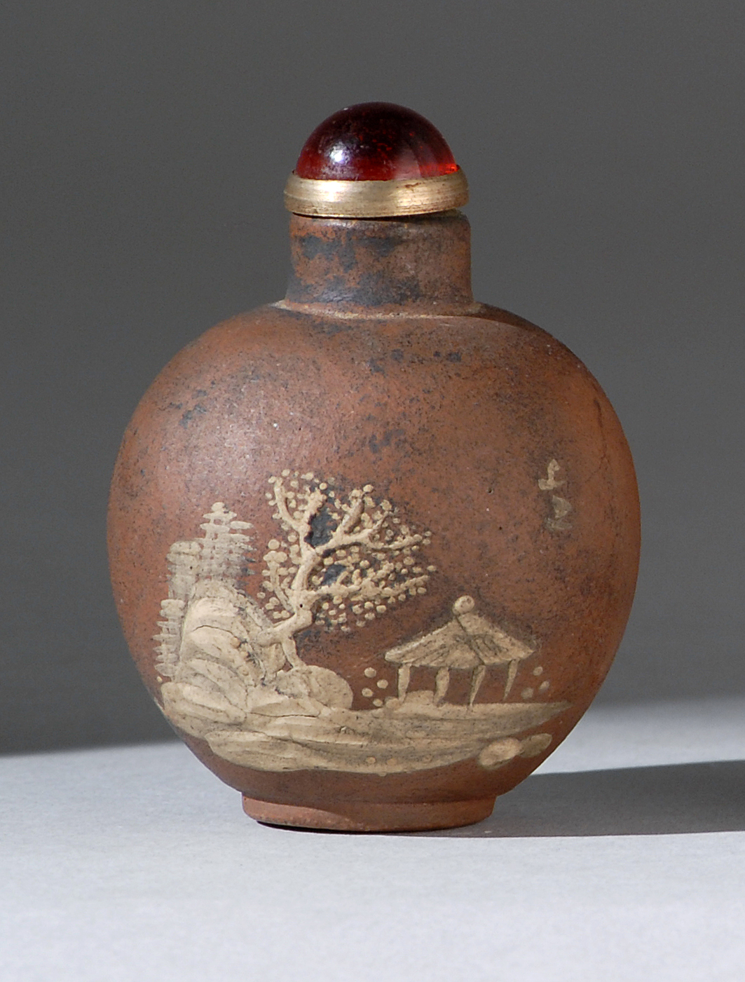 Appraisal: YIXING POTTERY SNUFF BOTTLE In ovoid form with p te-sur-p