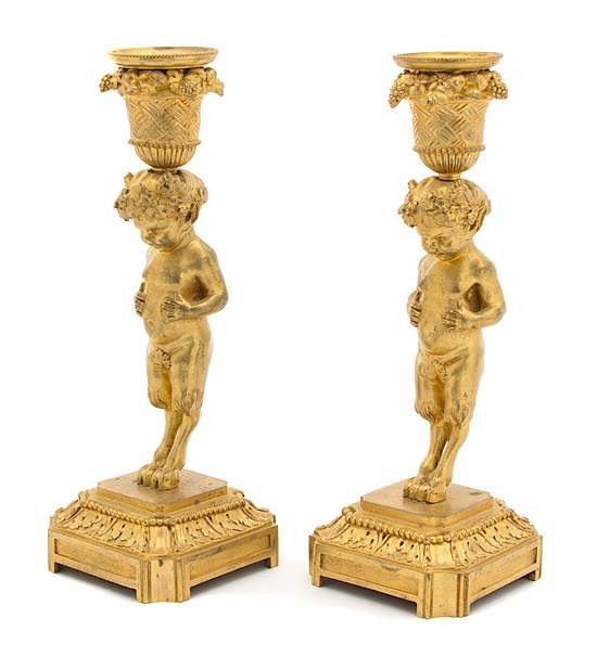 Appraisal: A Pair of French Gilt Bronze Candlesticks Height x diameter