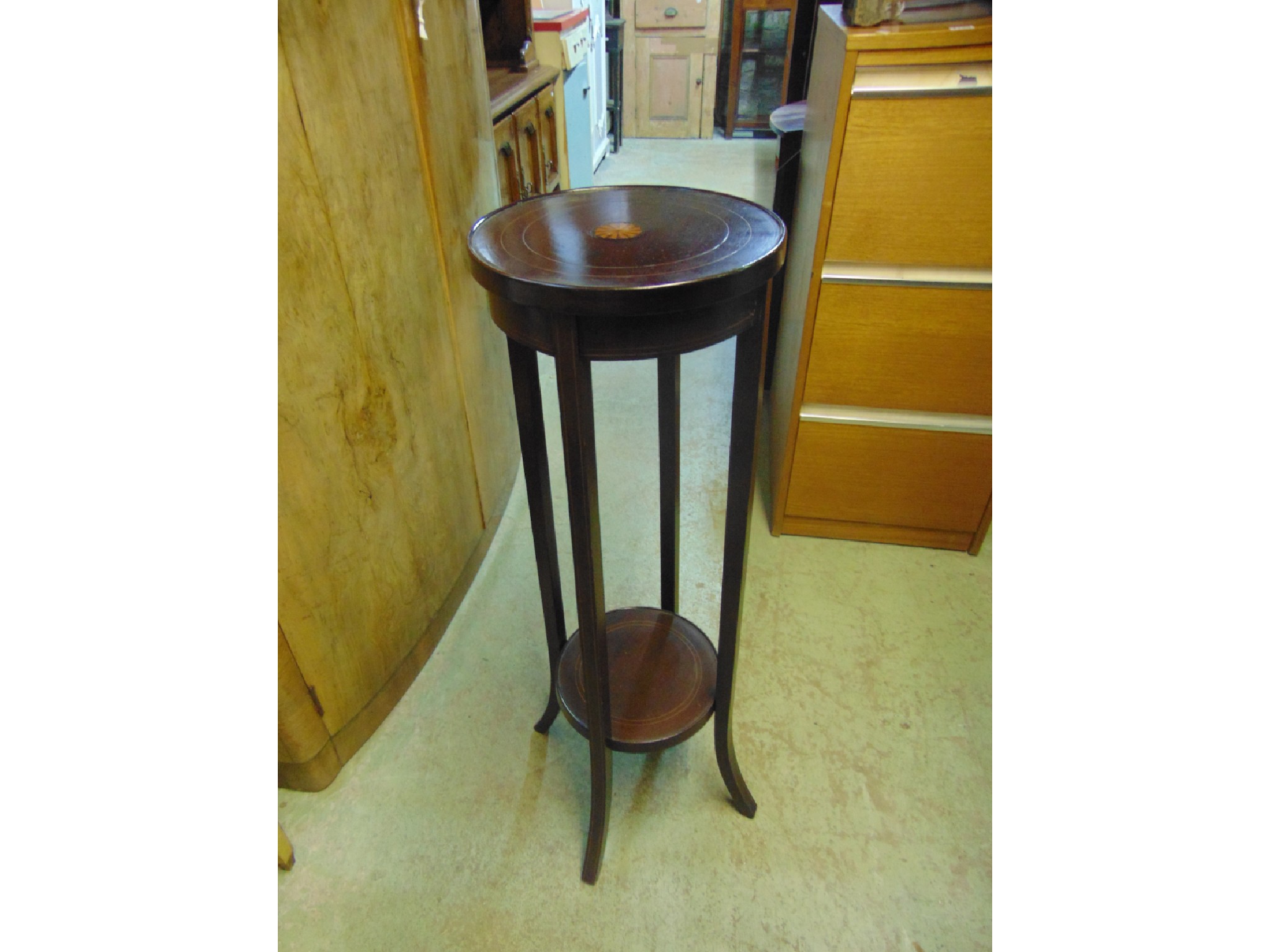 Appraisal: An inlaid Edwardian mahogany teir plant stand of circular form