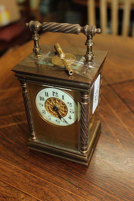 Appraisal: A SMALL BRASS CASED CARRIAGE TIMEPIECE with twisted cord columns