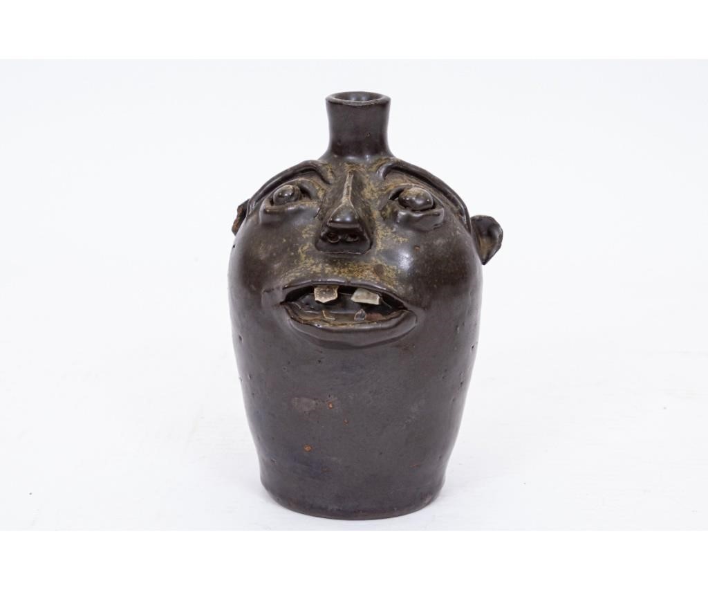 Appraisal: Small redware face jug with dark green glaze th c